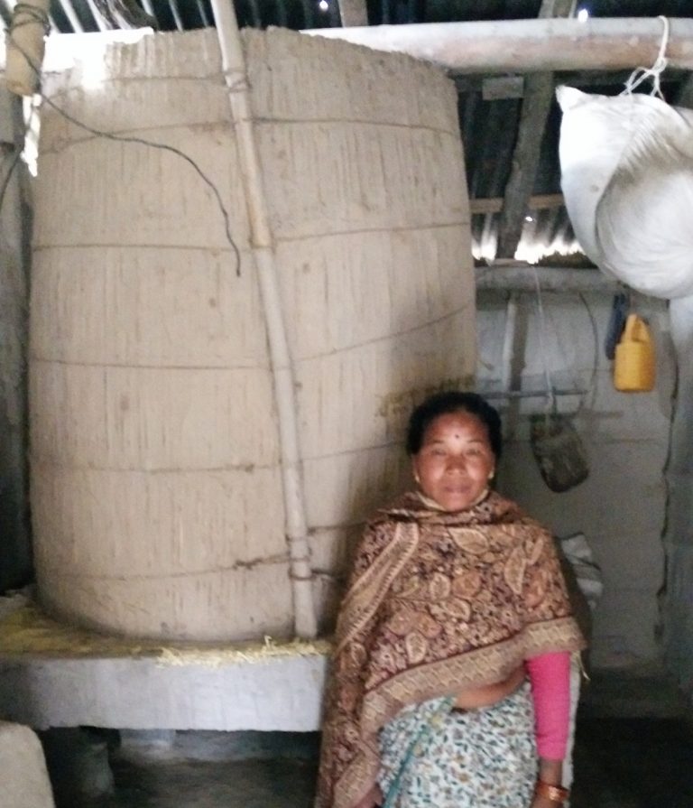 Mrs Mana Kumari Tharu and her elevated rice store