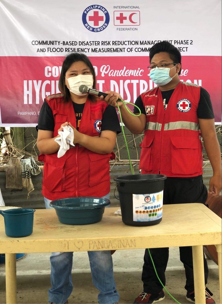 Philippine Red Cross demonstrating the importance of good hygiene practices during floods and to reduce the spread of COVID-19. Photo by Philippine Red Cross