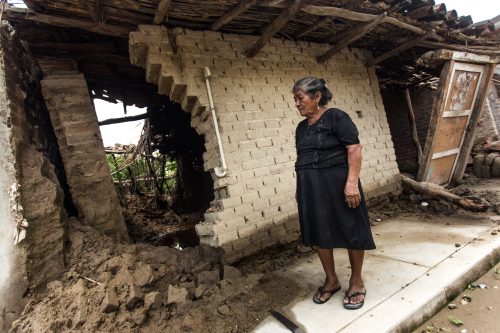 Woman surveying the damage of a flash flood on her home near Lima, Peru. Photo by Rodrigo Rodrich
